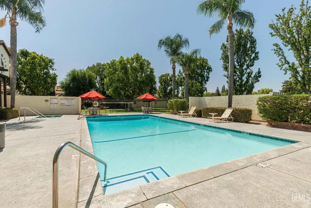 swimming pool view with a seating space and a garden view