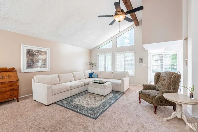 a living room with furniture a flat screen tv and a window
