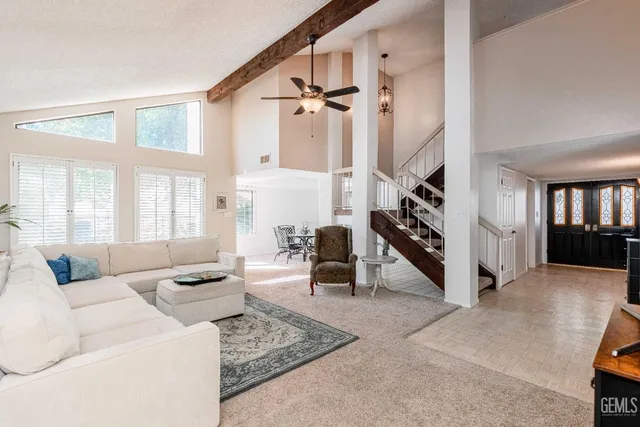 a living room with furniture and stairs