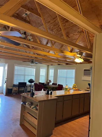 a living room with furniture kitchen view and a chandelier