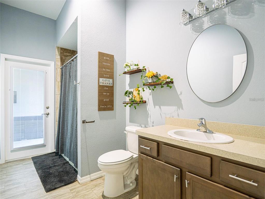 10688 Southwest 129th Terrace Road Dunnellon, FL 34432 - Photo 31 of 35 a bathroom with a toilet a sink and a mirror