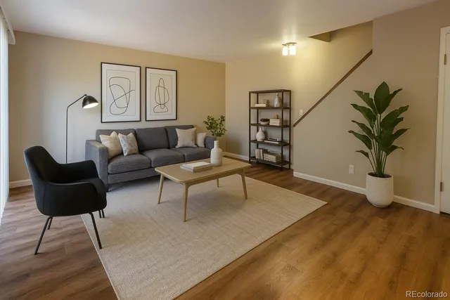 a living room with furniture and a potted plant