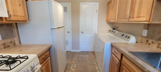 a utility room with a sink dryer and washer
