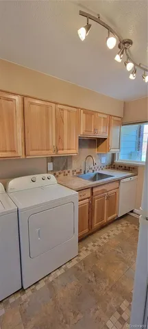 a kitchen that has a sink and a stove in it