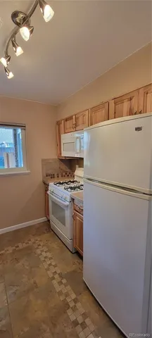 a kitchen with a refrigerator and a stove