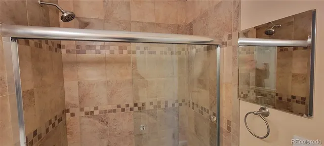 a bathroom with a shower and a sink
