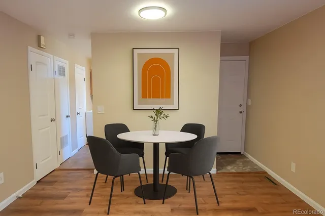 a view of a a dining room with furniture window and wooden floor