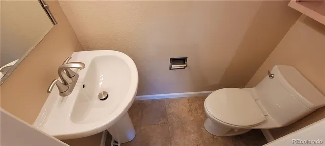 a bathroom with a toilet and a sink