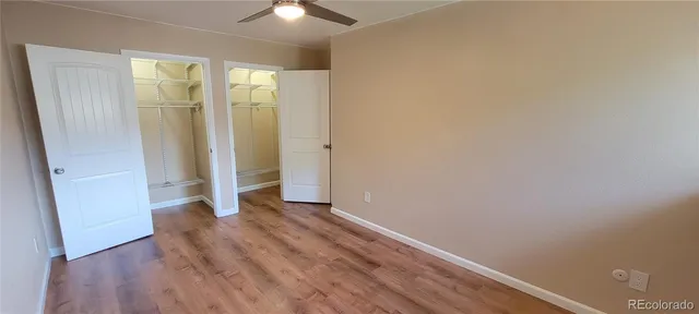 an empty room with wooden floor and closet