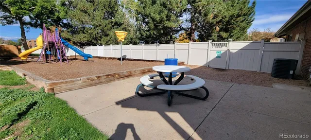 a view of swimming pool with lounge chair and dinning table under an umbrella