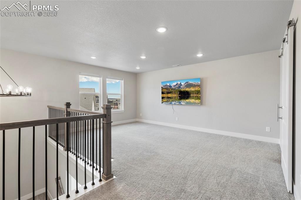 15777 Little Bluestem Road Monument, CO 80132 - Photo 26 of 50 a view of a hallway with a projector