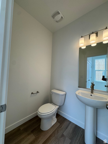 1883 West 1575th North, Unit 236 Layton, UT 84041 - Photo 7 of 22 Half bathroom with dark wood-style floors and toilet