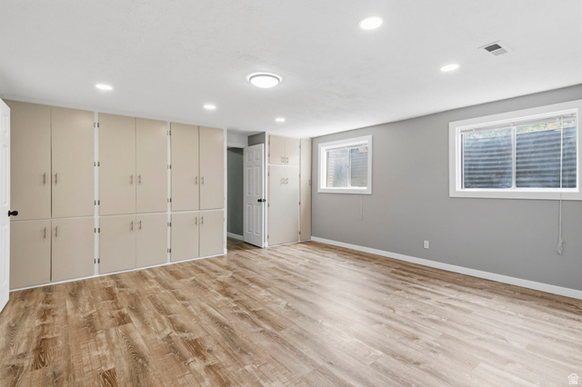 2693 Teal Way Sandy, UT 84093 - Photo 30 of 50 Expansive room featuring extensive built-in cabinetry, wood-finish flooring, two windows, and recessed lighting