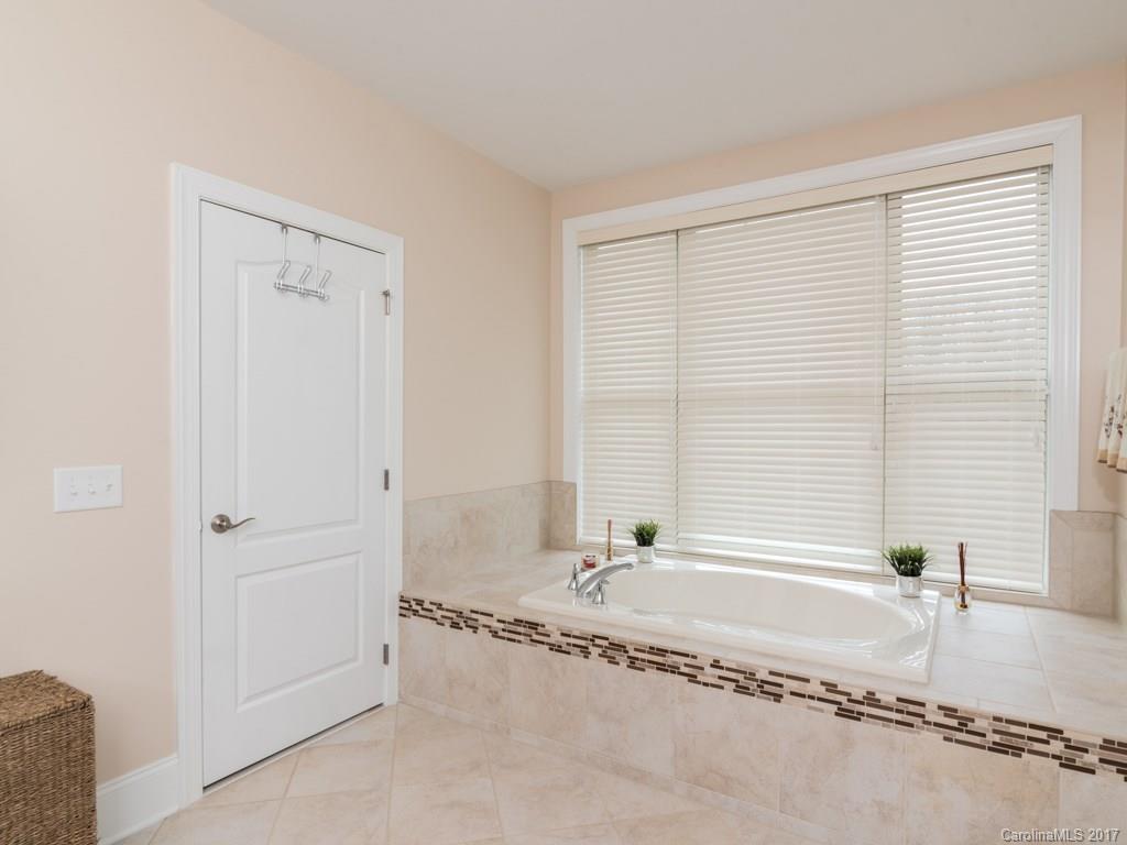 7005 Tea Olive Road Marvin, NC 28173 - Photo 11 of 24 a spacious bathroom with a tub and a sink