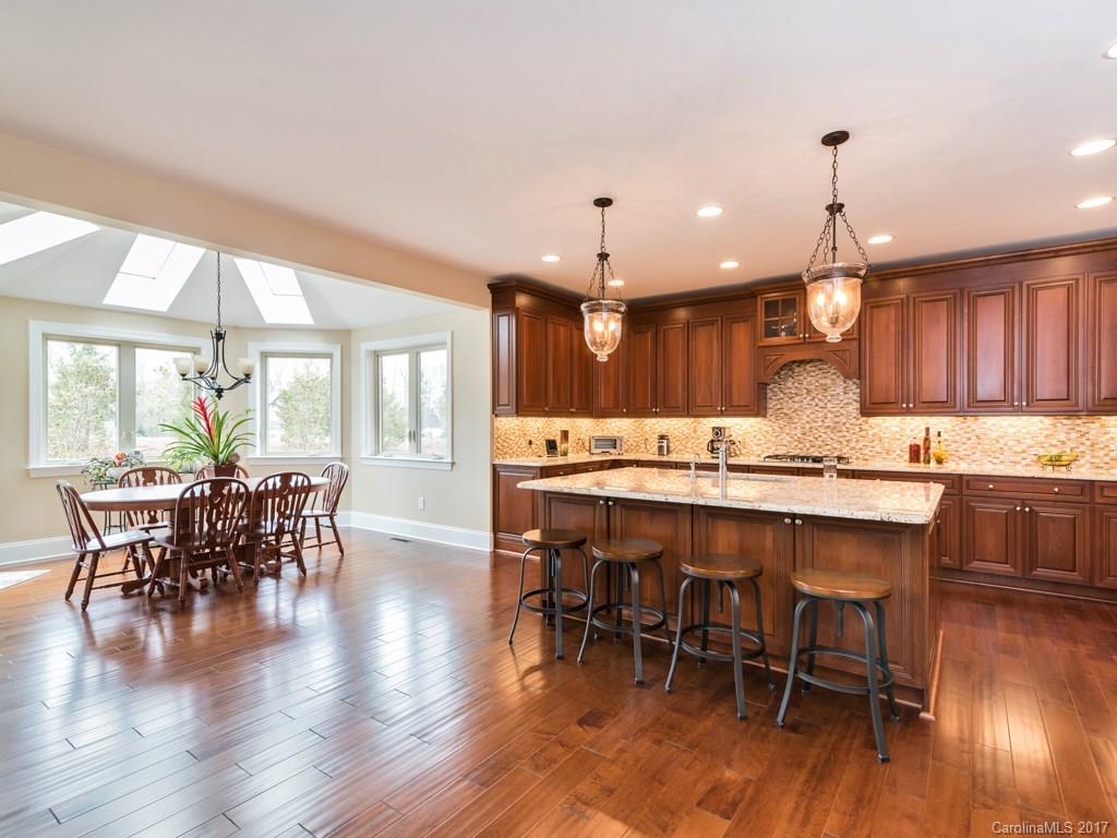 7005 Tea Olive Road Marvin, NC 28173 - Photo 12 of 24 a large kitchen with a table and chairs