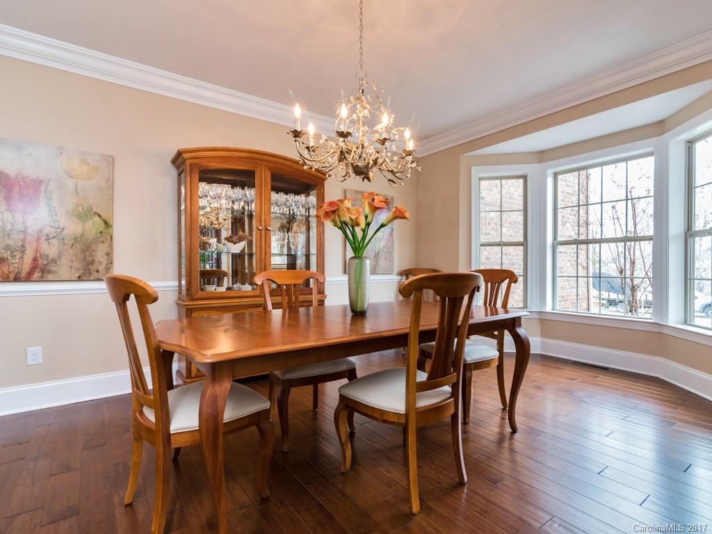 7005 Tea Olive Road Marvin, NC 28173 - Photo 6 of 24 a dining room with furniture potted plants and wooden floor