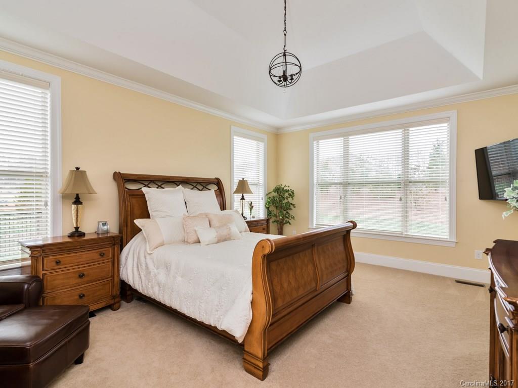 7005 Tea Olive Road Marvin, NC 28173 - Photo 9 of 24 a bedroom with a bed lamp and a large window