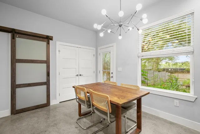 a view of a dining room with furniture and a chandelier