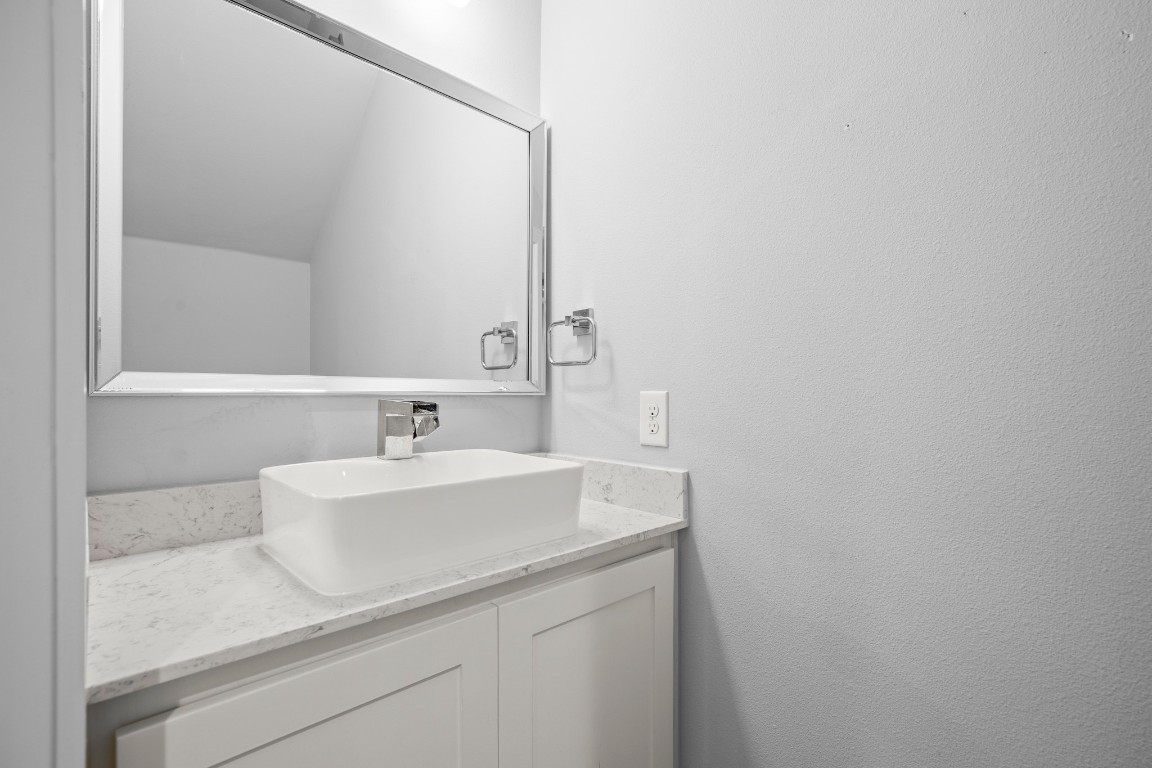 1220 Delano Street, Unit B Austin, TX 78721 - Photo 12 of 24 a bathroom with a sink and a mirror