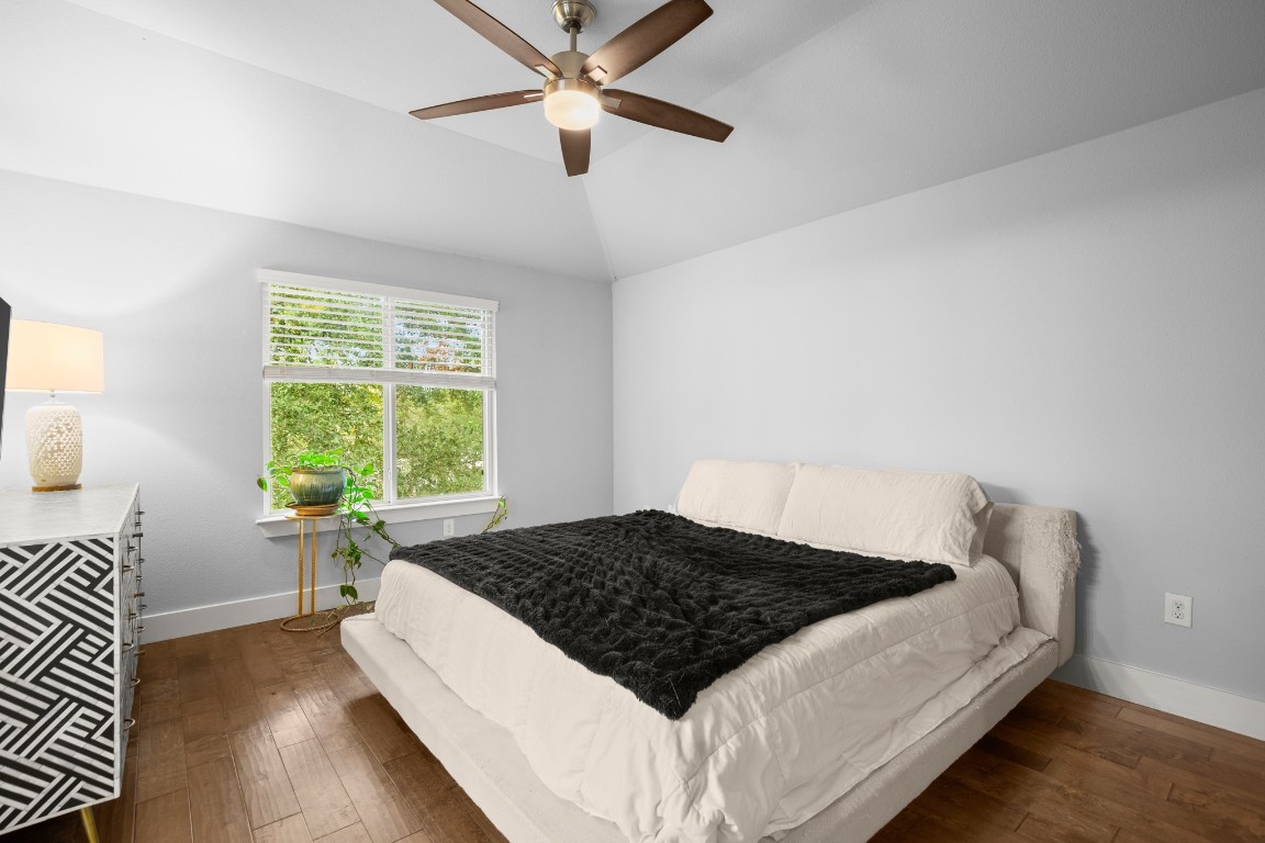 1220 Delano Street, Unit B Austin, TX 78721 - Photo 14 of 24 a large bed sitting in a bedroom next to a window