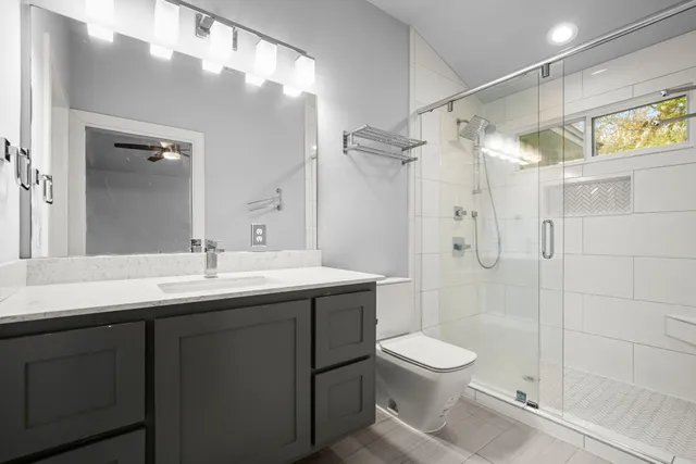 a bathroom with a toilet a sink and shower