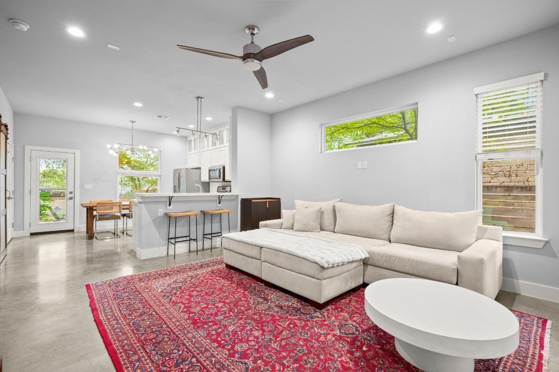 1220 Delano Street, Unit B Austin, TX 78721 - Photo 2 of 24 a living room with furniture a rug and a chandelier