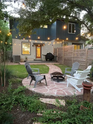 a view of a backyard with sitting area and furniture