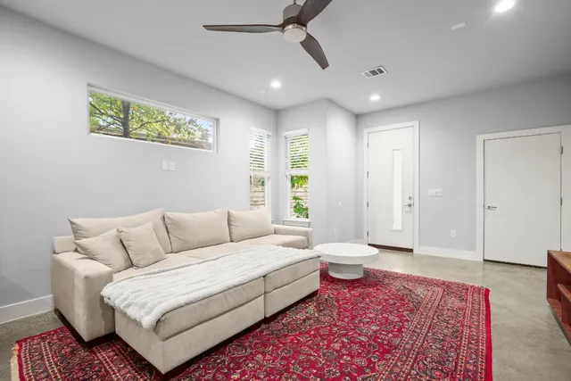 a spacious bedroom with a bed a couch and a window