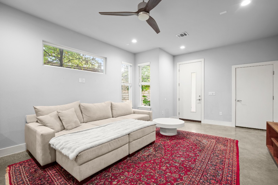 1220 Delano Street, Unit B Austin, TX 78721 - Photo 4 of 24 a spacious bedroom with a bed a couch and a window