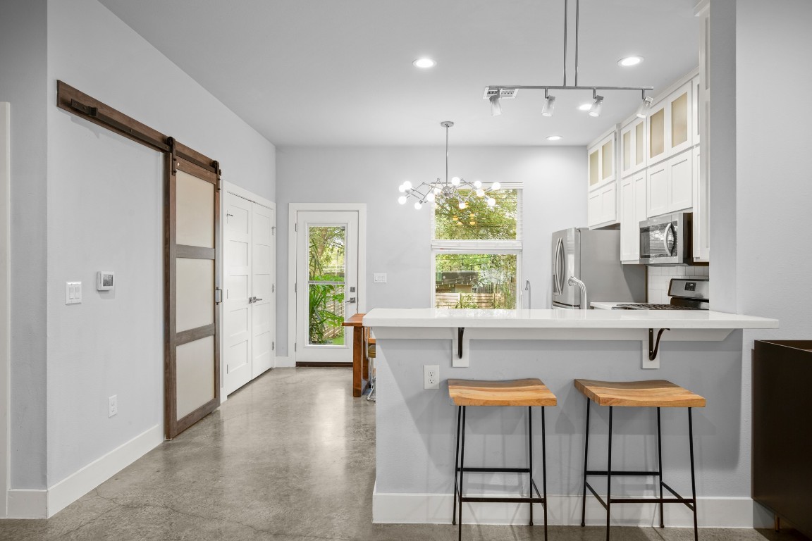 1220 Delano Street, Unit B Austin, TX 78721 - Photo 6 of 24 a large white kitchen with a large window