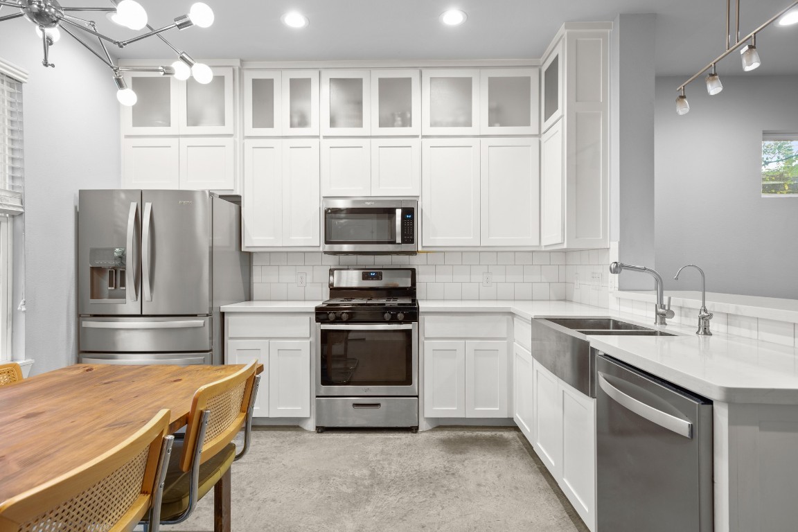 1220 Delano Street, Unit B Austin, TX 78721 - Photo 8 of 24 a kitchen with stainless steel appliances granite countertop a refrigerator stove and sink