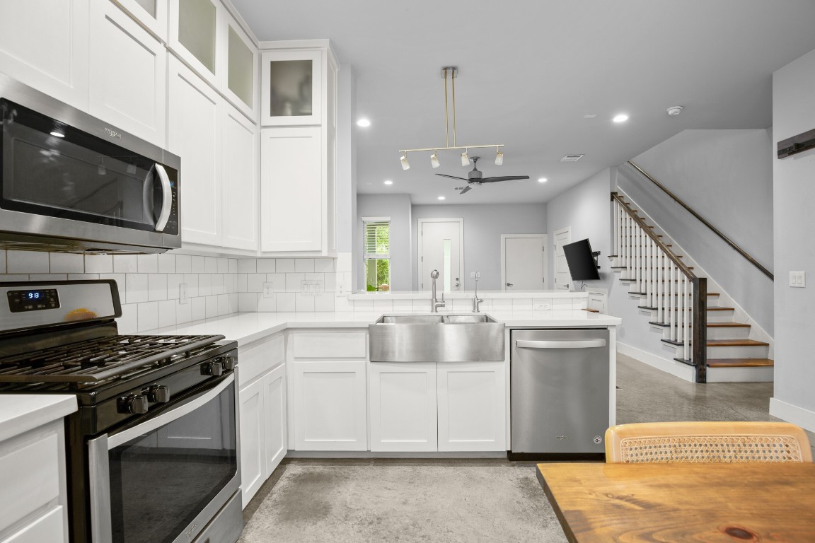 1220 Delano Street, Unit B Austin, TX 78721 - Photo 10 of 24 a kitchen with stainless steel appliances granite countertop a sink and a stove