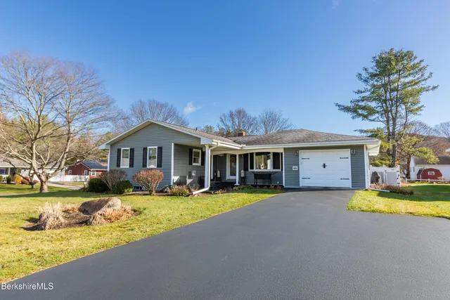 a view of a house with swimming pool and yard