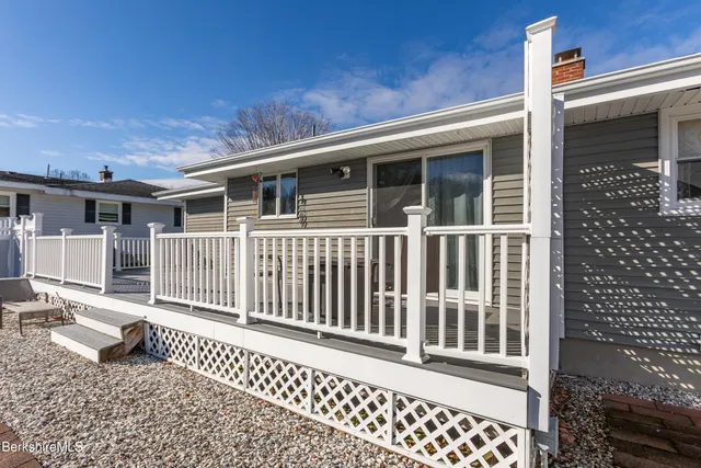 a backyard of a house with a bench