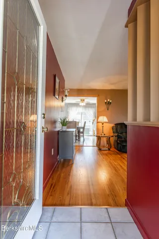 a living room with furniture a flat screen tv and floor to ceiling window