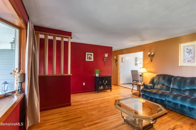 a living room with furniture a rug and a lamp