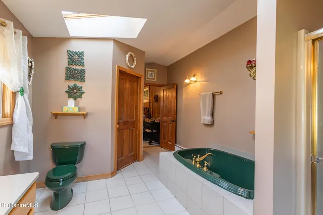 a bathroom with a tub shower and sink