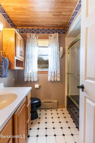 a bathroom with a sink mirror vanity and toilet