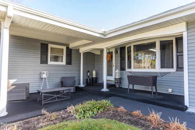 a front view of a house with a garden