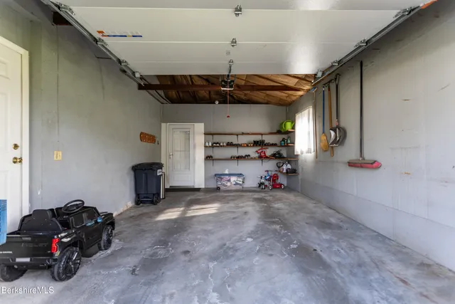 a view of a garage with rack and bicycle