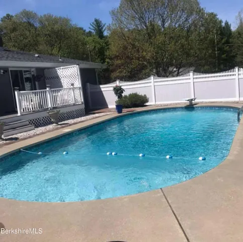 a view of a backyard with sitting area