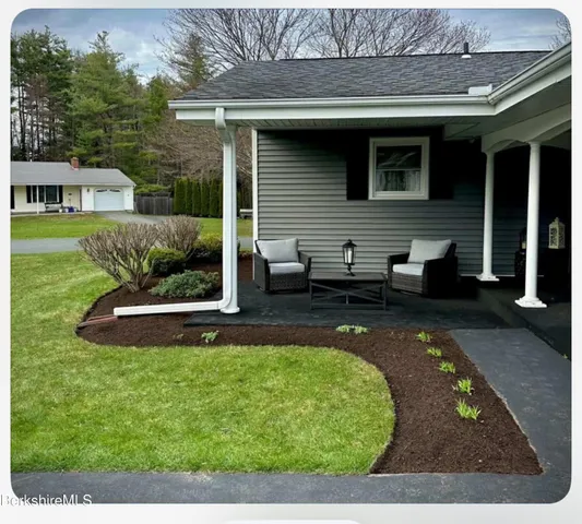 a view of a backyard with swimming pool