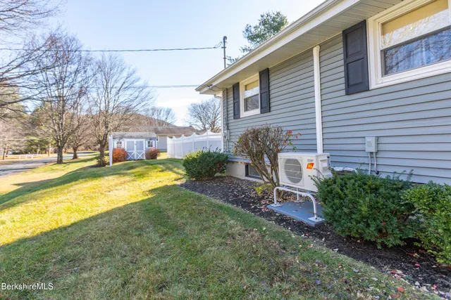 a view of a house with a yard and sitting area