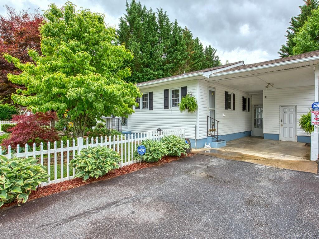 154 Camp Branch Road Waynesville, NC 28786 - Photo 1 of 29 a front view of a house with a garden and plants