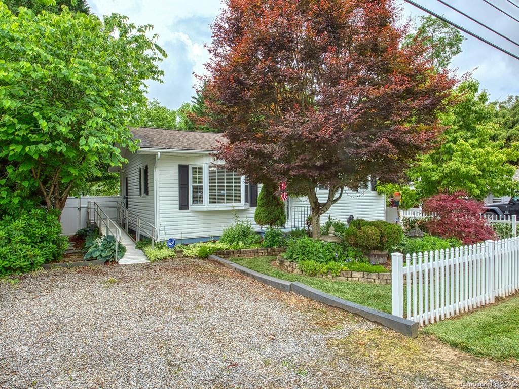 154 Camp Branch Road Waynesville, NC 28786 - Photo 2 of 29 a front view of a house with garden