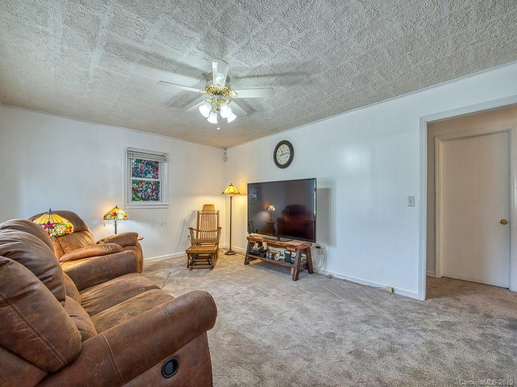154 Camp Branch Road Waynesville, NC 28786 - Photo 17 of 29 a living room with furniture and a flat screen tv