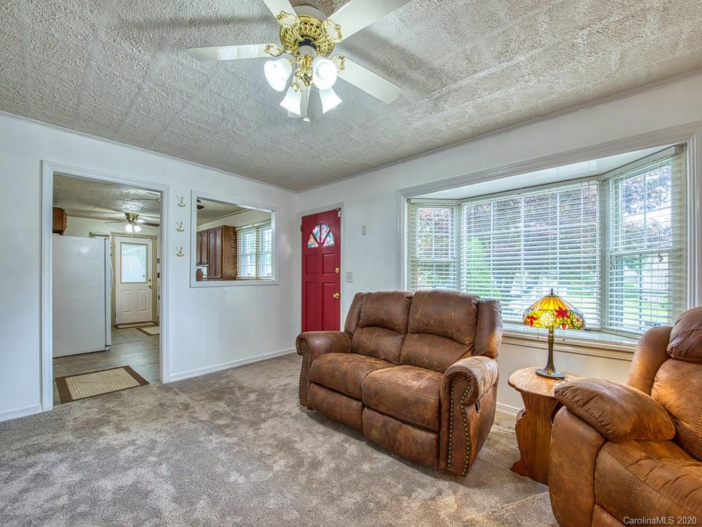 154 Camp Branch Road Waynesville, NC 28786 - Photo 18 of 29 a living room with furniture and a large window