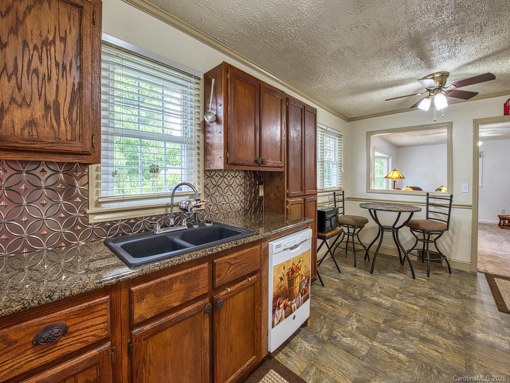 154 Camp Branch Road Waynesville, NC 28786 - Photo 19 of 29 a kitchen with granite countertop sink cabinets and window