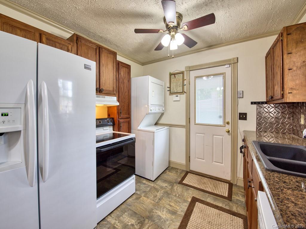 154 Camp Branch Road Waynesville, NC 28786 - Photo 21 of 29 a kitchen with a refrigerator a stove a washer and dryer