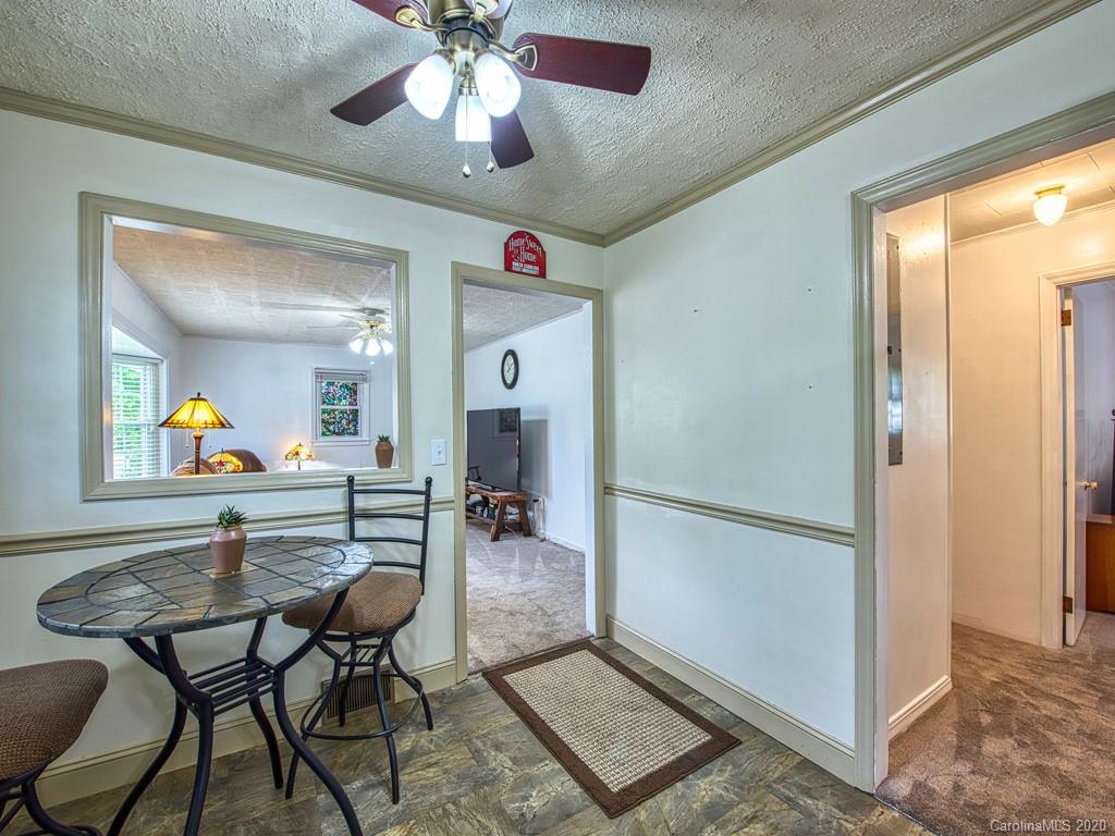 154 Camp Branch Road Waynesville, NC 28786 - Photo 22 of 29 a view of a dining room with furniture and a chandelier